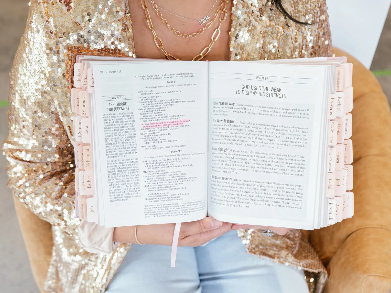 An open Bible held with highlighted passages